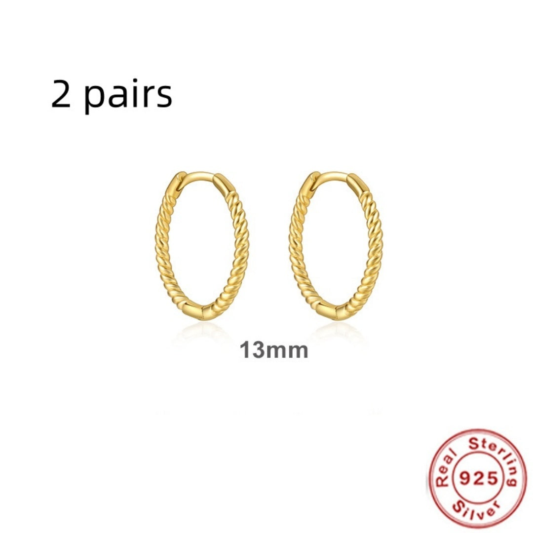 Gold hoop earrings with 'Real Sterling 925' stamp on a white background