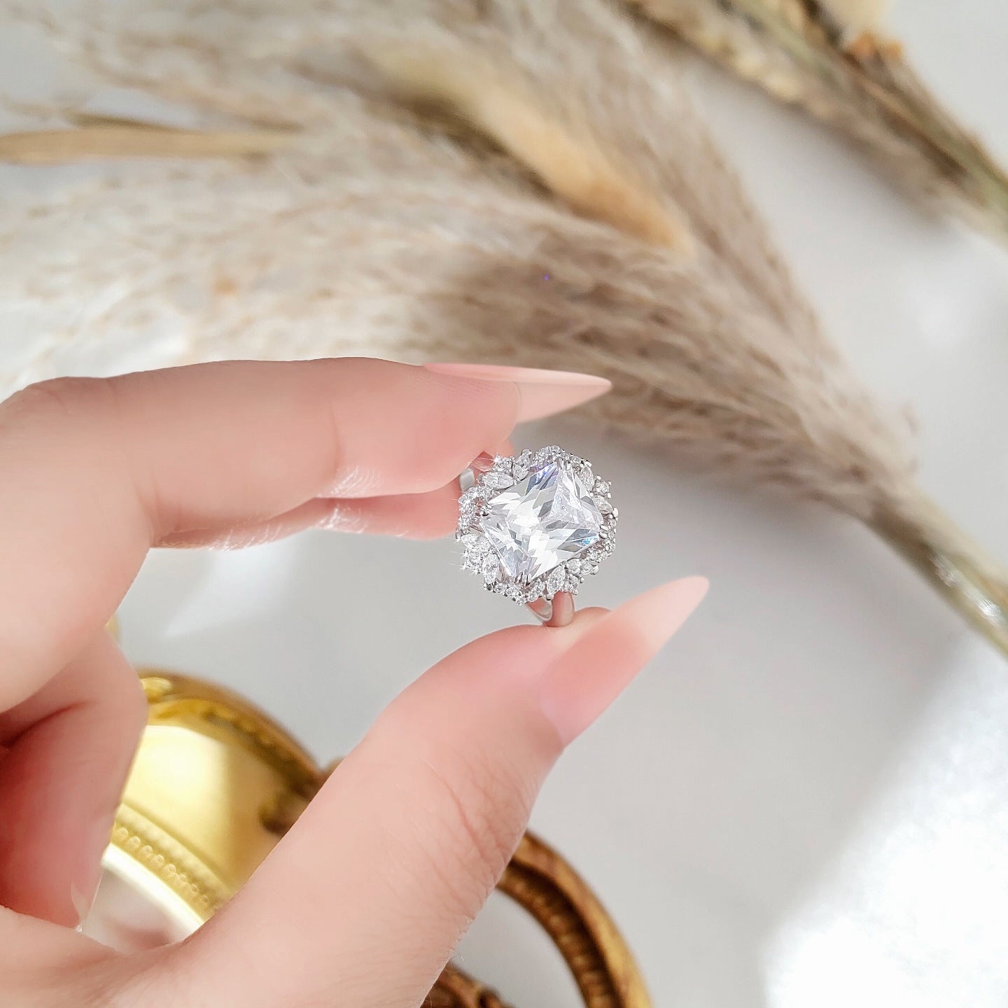 Zircon 810 ring held between fingers with a blurred background
