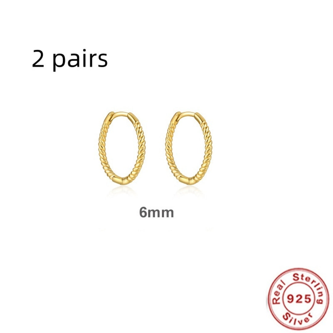 Two pairs of gold hoop earrings with a 'Real Sterling 925' stamp on a white background.