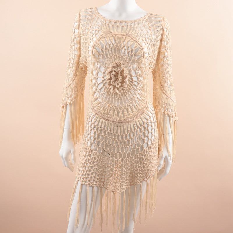 Beige Macrame dress with fringe on a mannequin against a beige background