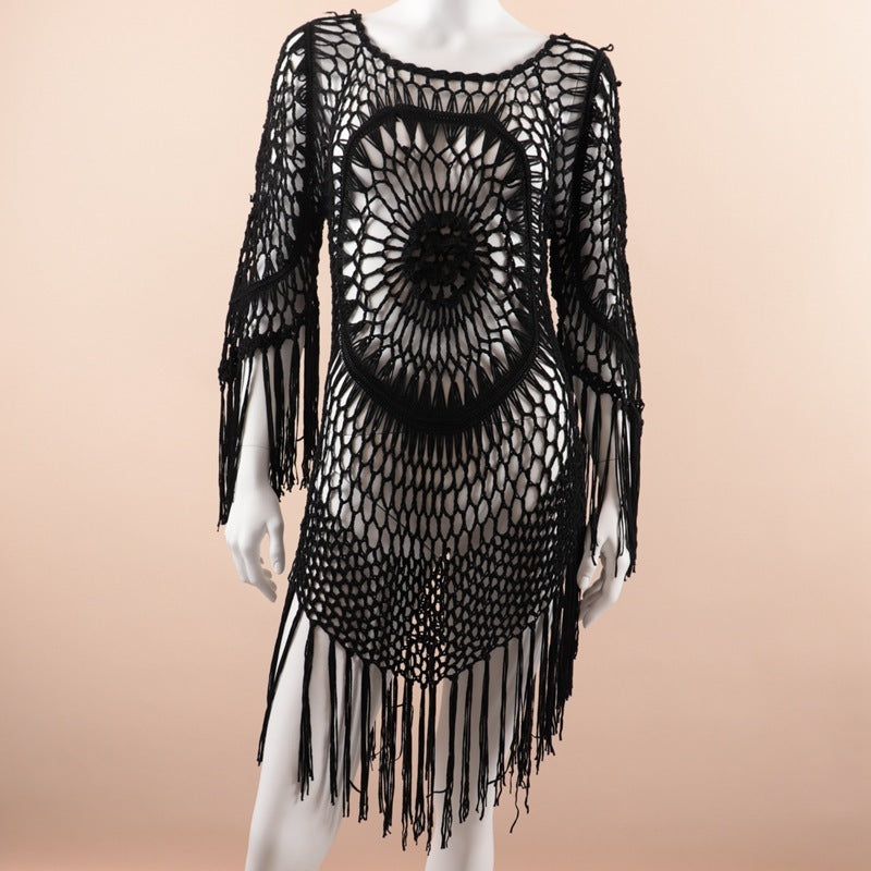 Black Macrame dress with fringe on a mannequin against a beige background