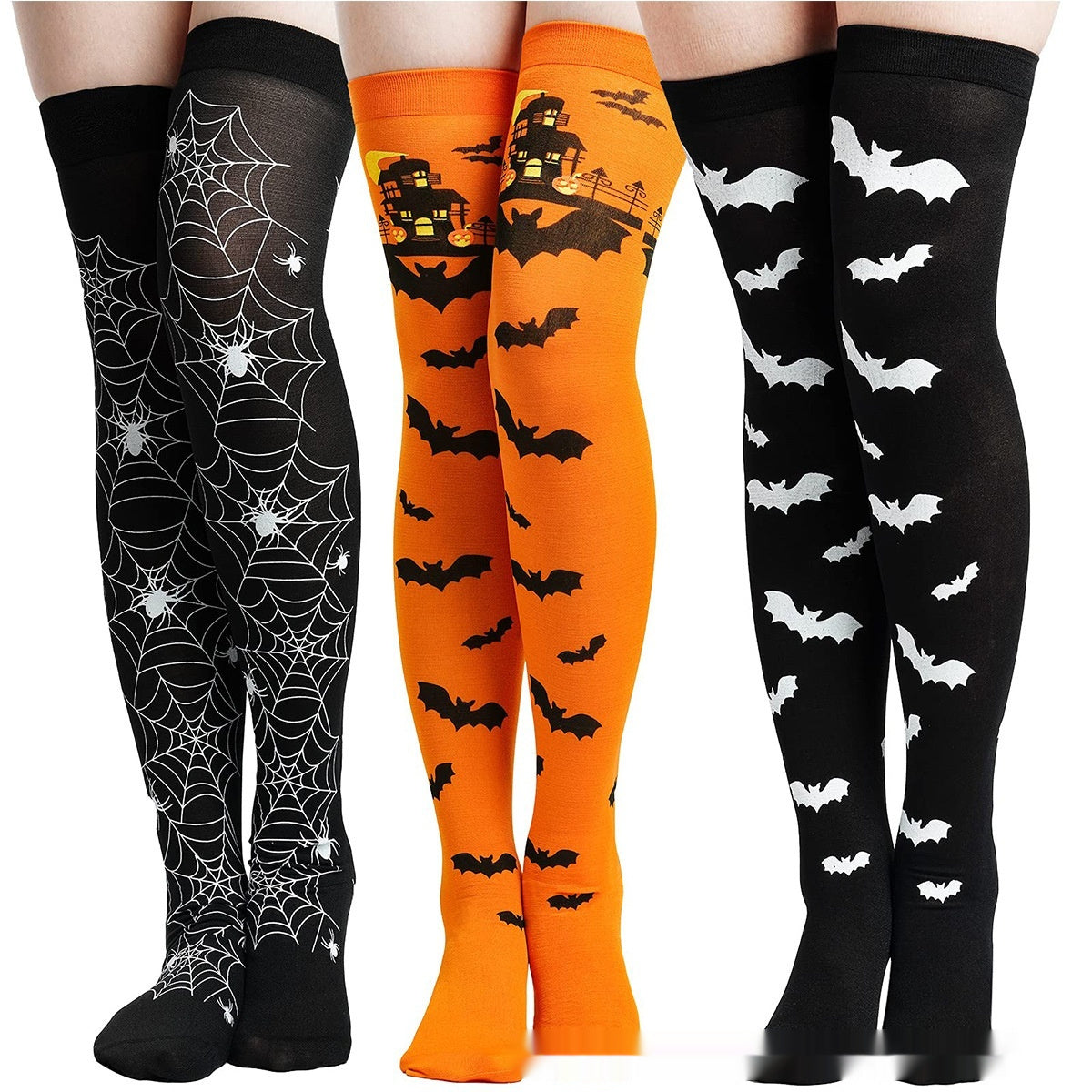 Three pairs of Halloween-themed knee-high socks with spider webs, bats, and a haunted house design.