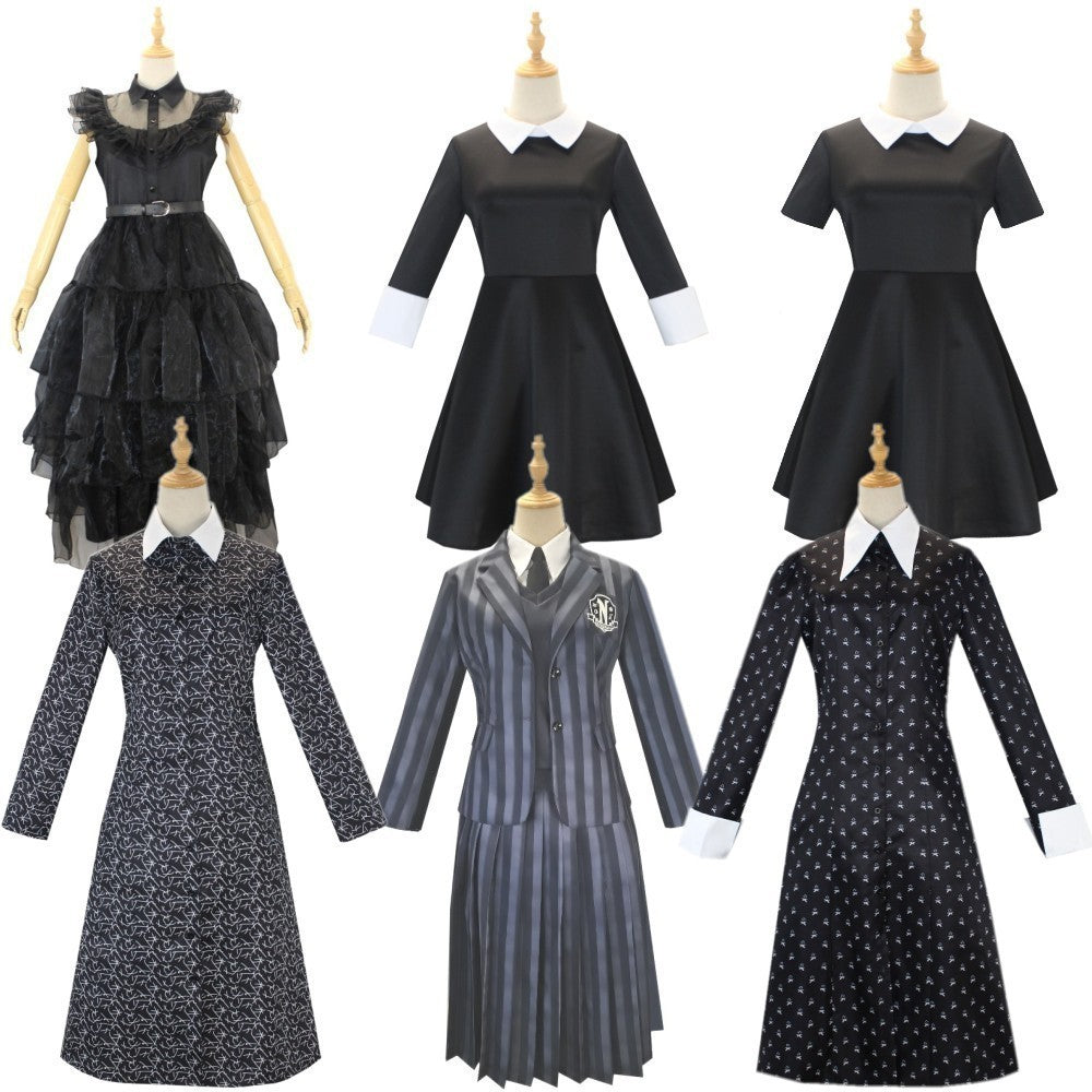 Collection of black and gray dresses on mannequins against a white background