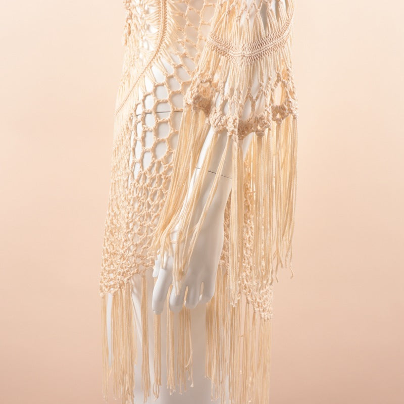 Macrame wall hanging with beige threads on a light pink background