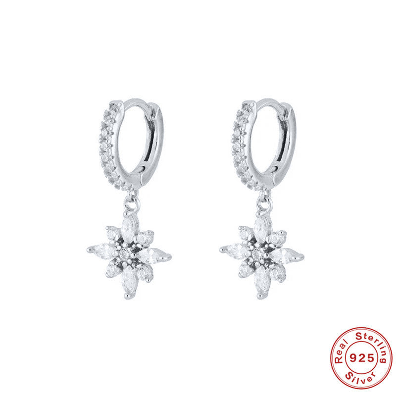 Silver earrings with floral design on a white background, featuring 'Real Sterling 925' stamp.