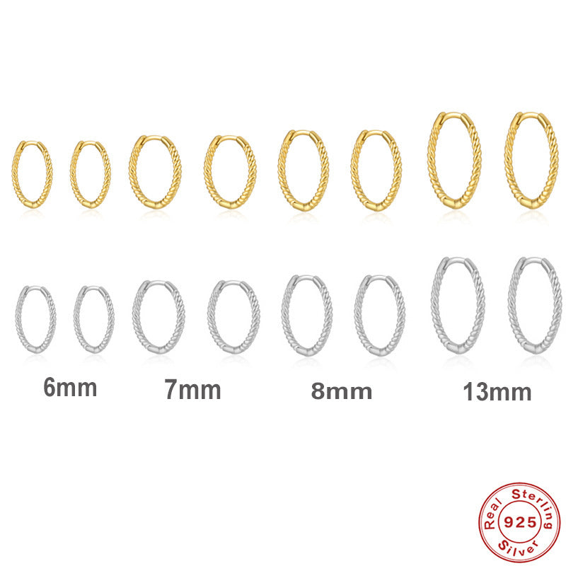Set of gold and silver hoop earrings in various sizes on a white background.