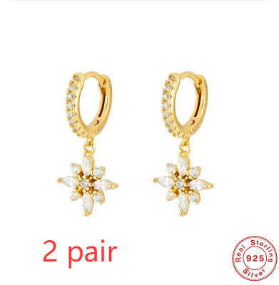 Gold hoop earrings with drops on a floral style white background, featuring '2 pair' text and a stamp.