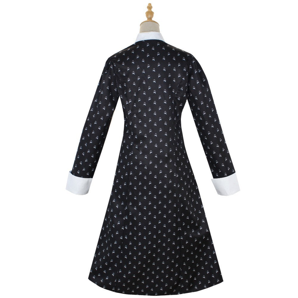 Black dress with white floral pattern on a mannequin against a white background