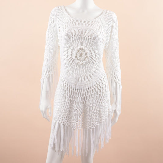 White Macrome dress with fringe on a mannequin against a beige background